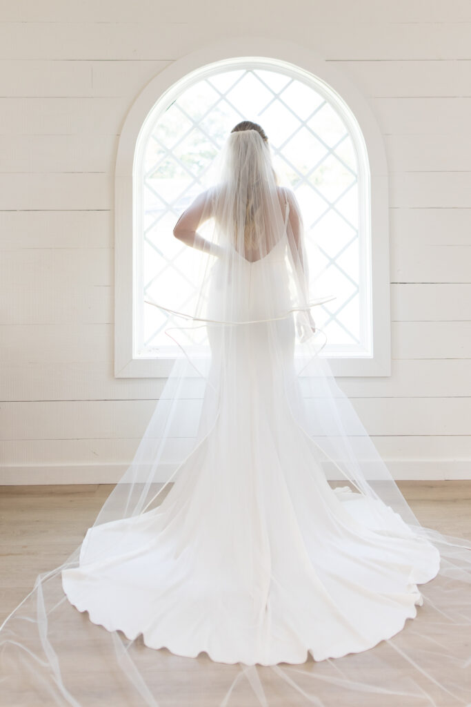 Bridal portrait in front of chapel window at hummingbird hill tx taken by cecilly elaine photography