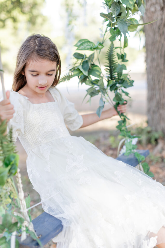 Fairy garden swing portraits in white dress