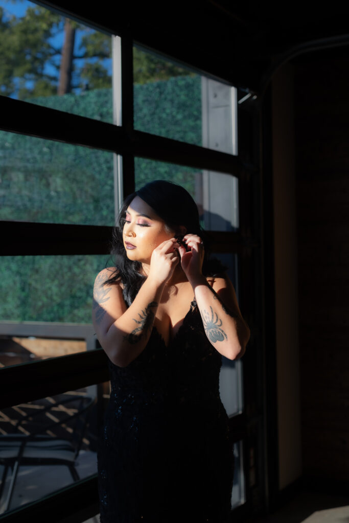 Bride in black dress getting ready