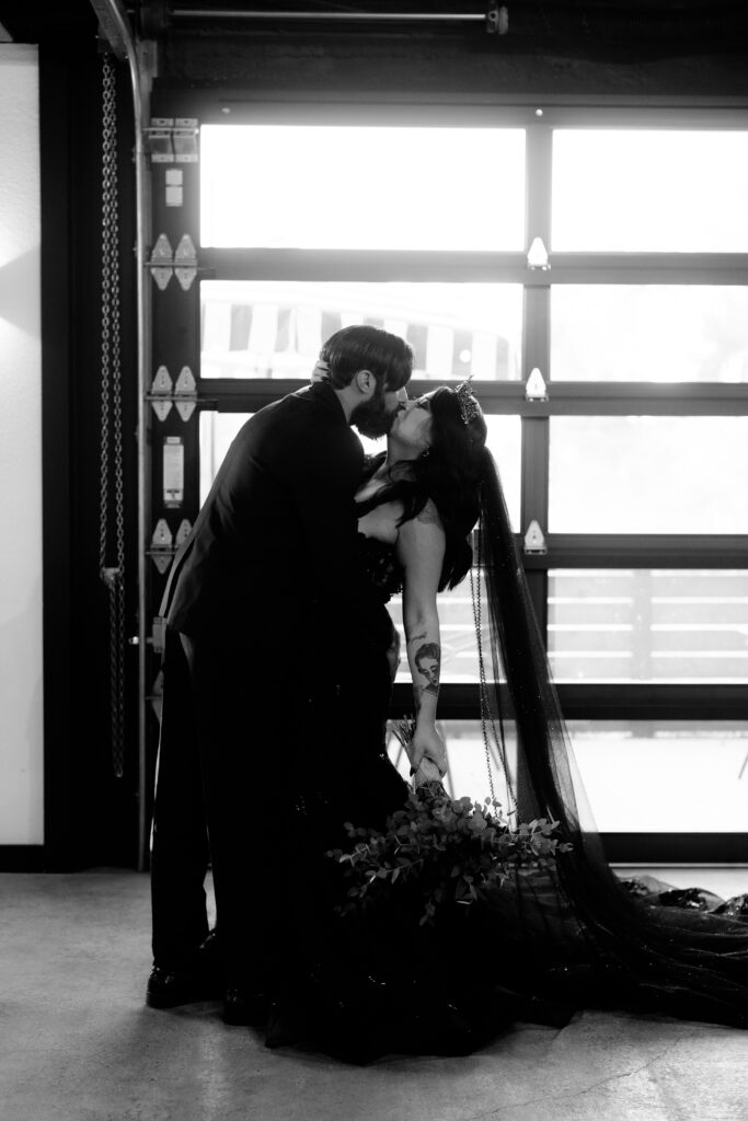 Bride and groom kiss moody gothic wedding