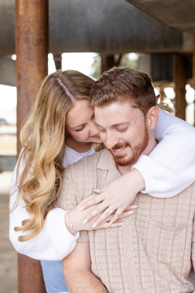 Hugging engaged couple in neutral colors